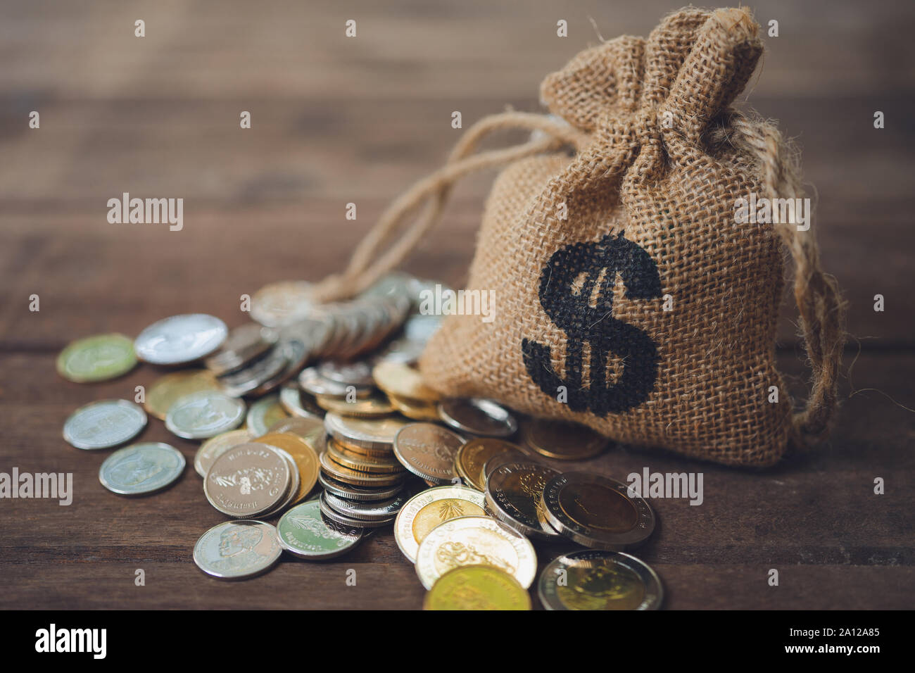 Money bags put on the pile of money. as background business concept and Saving concept with  copy space for your text or design. Stock Photo