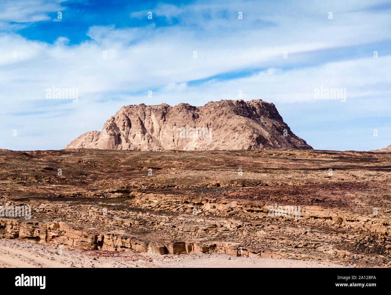 high mountain in the desert against the blue sky and white clouds Stock ...