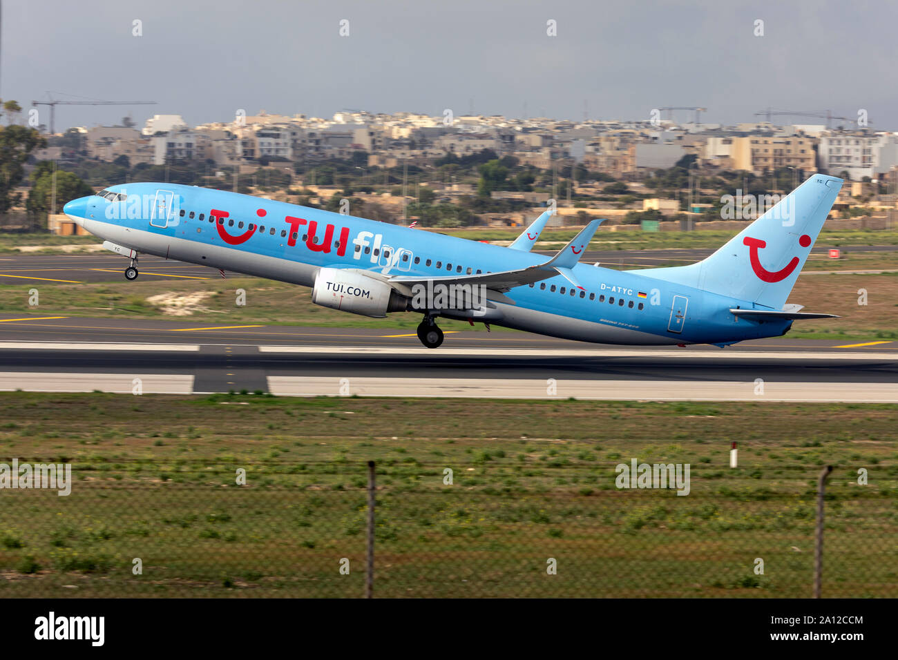 TUIfly Boeing 737-8K5 (REG: D-ATYC) on take off from runway 13 in the morning. Stock Photo