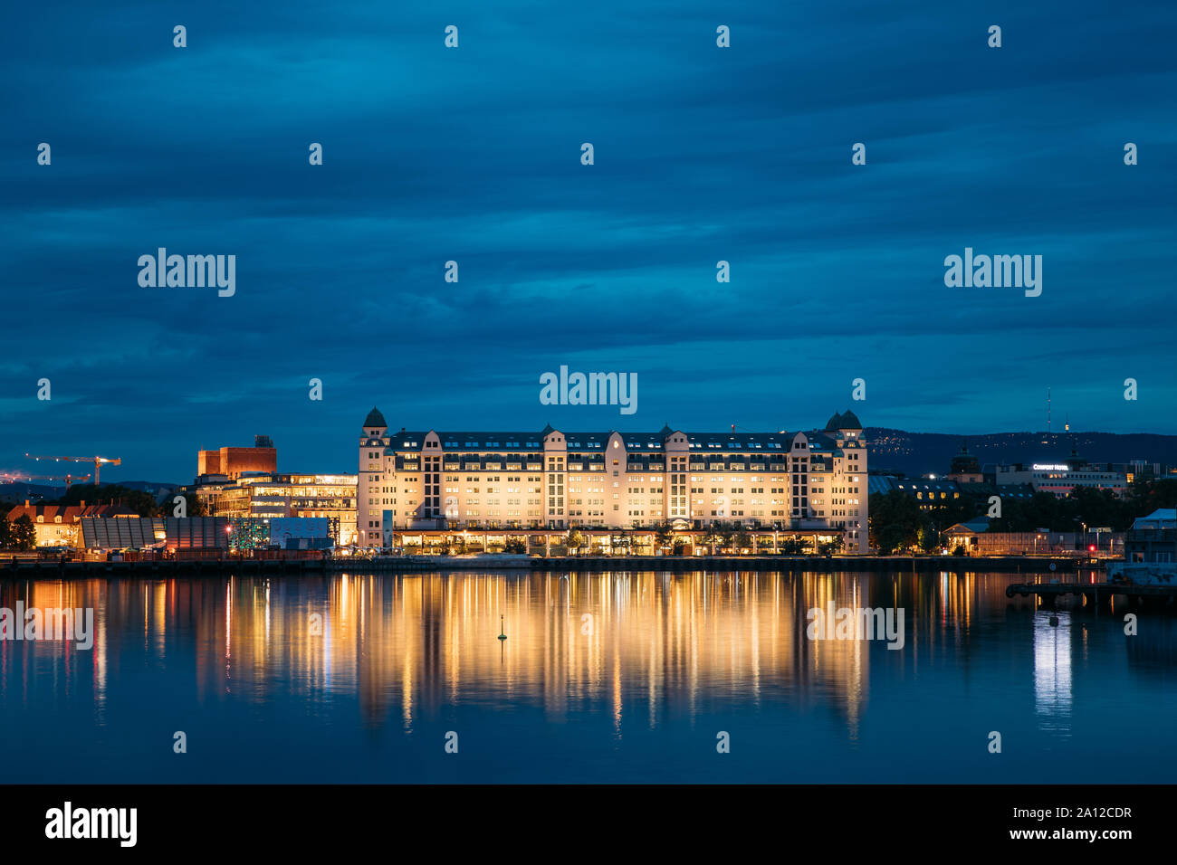Oslo, Norway - June 25, 2019: Night View Embankment And Residential Multi-storey House On Langkaia Street In City Center In Oslo, Norway. Summer Eveni Stock Photo