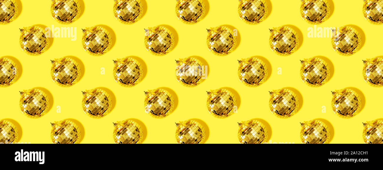 Christmas Gold Baubles Organized On Yellow Background Top View