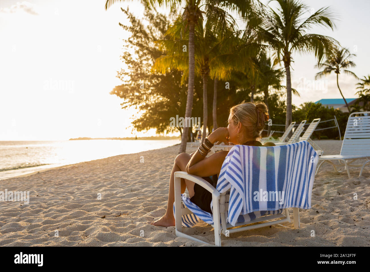 Woman sitting in beach chair hires stock photography and images Alamy