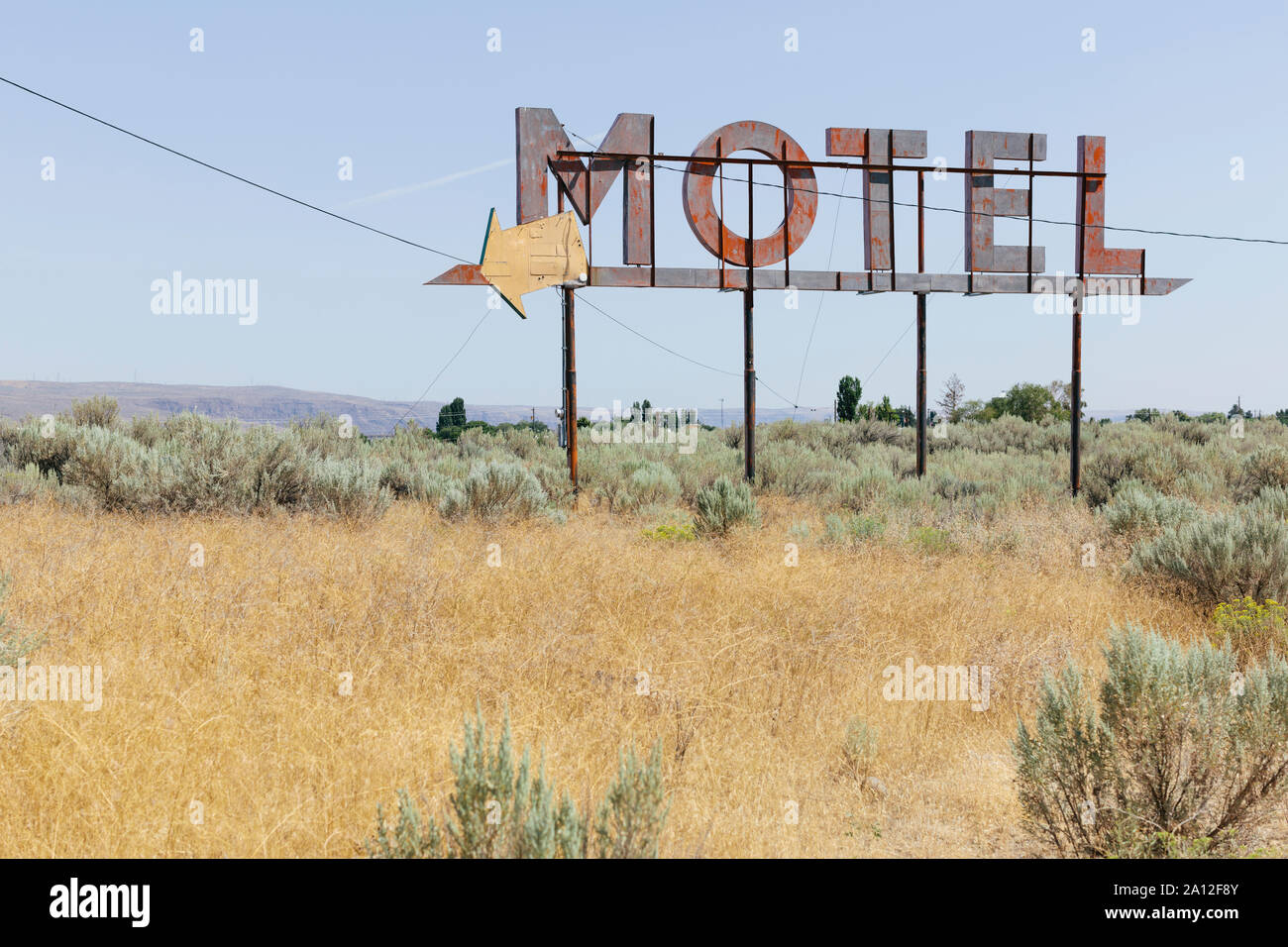 Vintage motel sign with dry scrub-land in foreground, Whitman County, Palouse, Washington, USA. Stock Photo