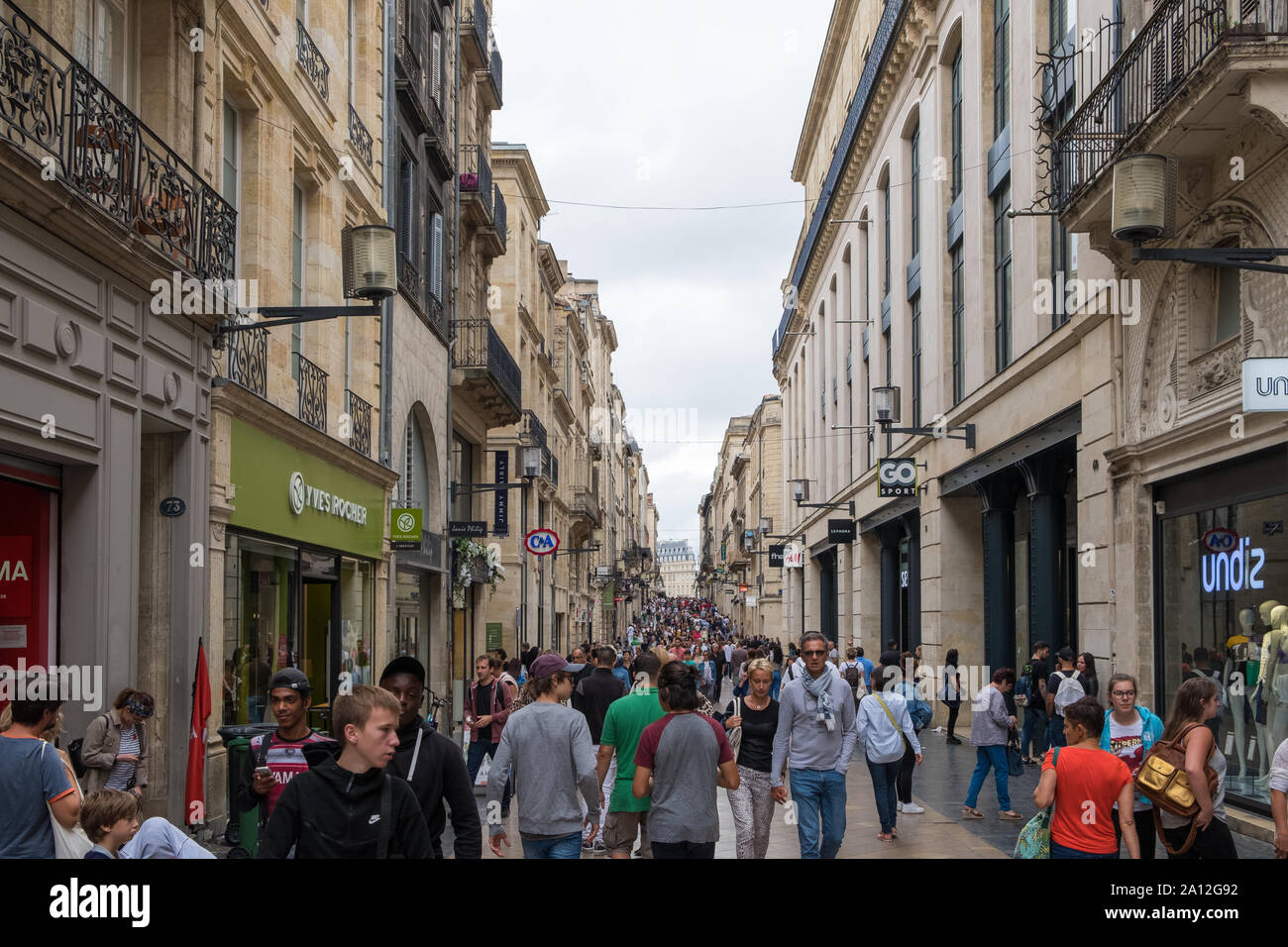 Crowds of people walking along the shopping street of Rue Sainte ...