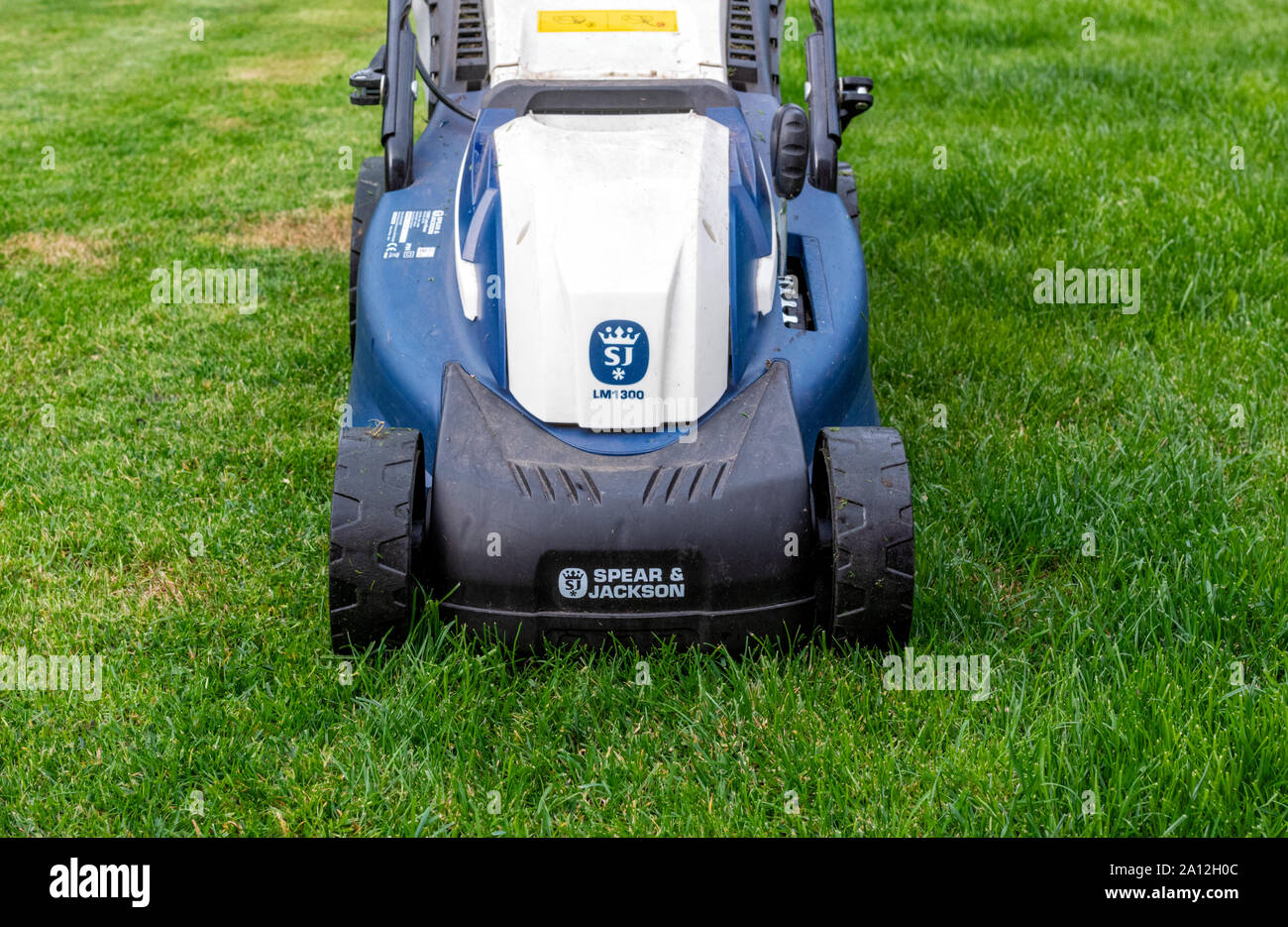 Close up of the front of a Spear and Jackson electric lawnmower on a garden lawn Stock Photo