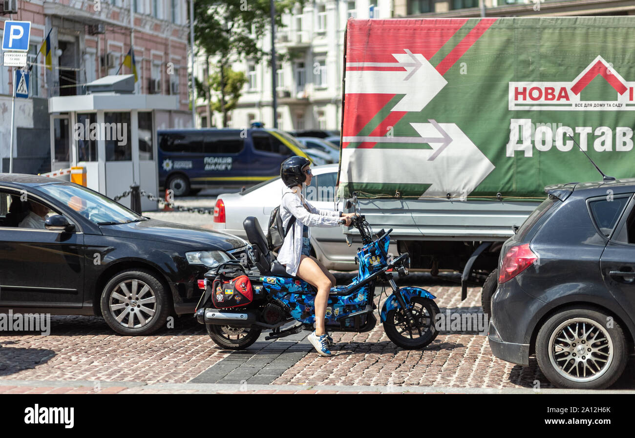 Kyiv, Ukraine, June 8, 2019. Girl on a motorcycle rides in a traffic jam on Volodymyrska Street Stock Photo