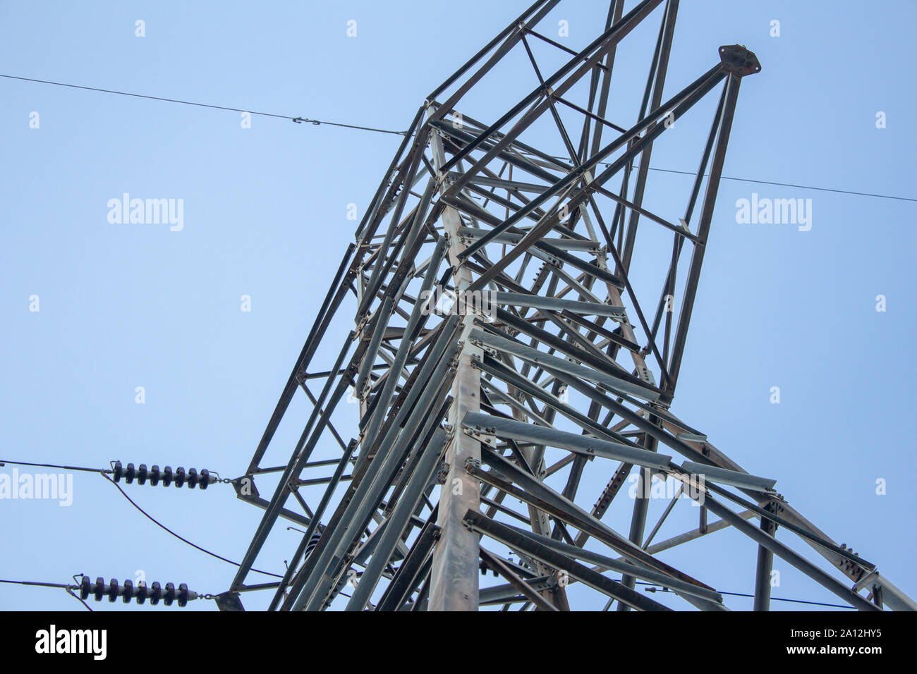 View of high voltage electric pole with blue sky background Stock Photo