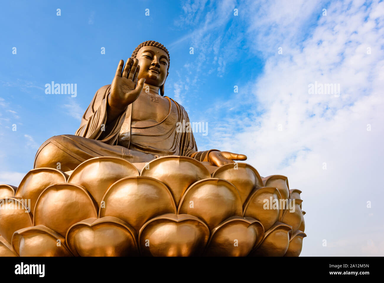 Giant Buddha statue with blue sky at Zhengjue Temple, Jilin, China Stock Photo