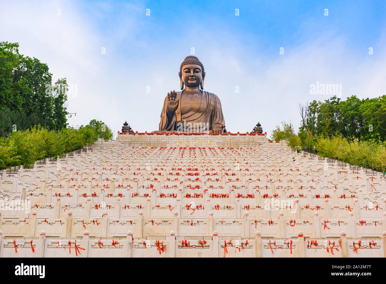 Jilin, China - 02 September 2016: Giant Buddha statue with blue sky at Zhengjue Temple, Heilongjiang, China Stock Photo