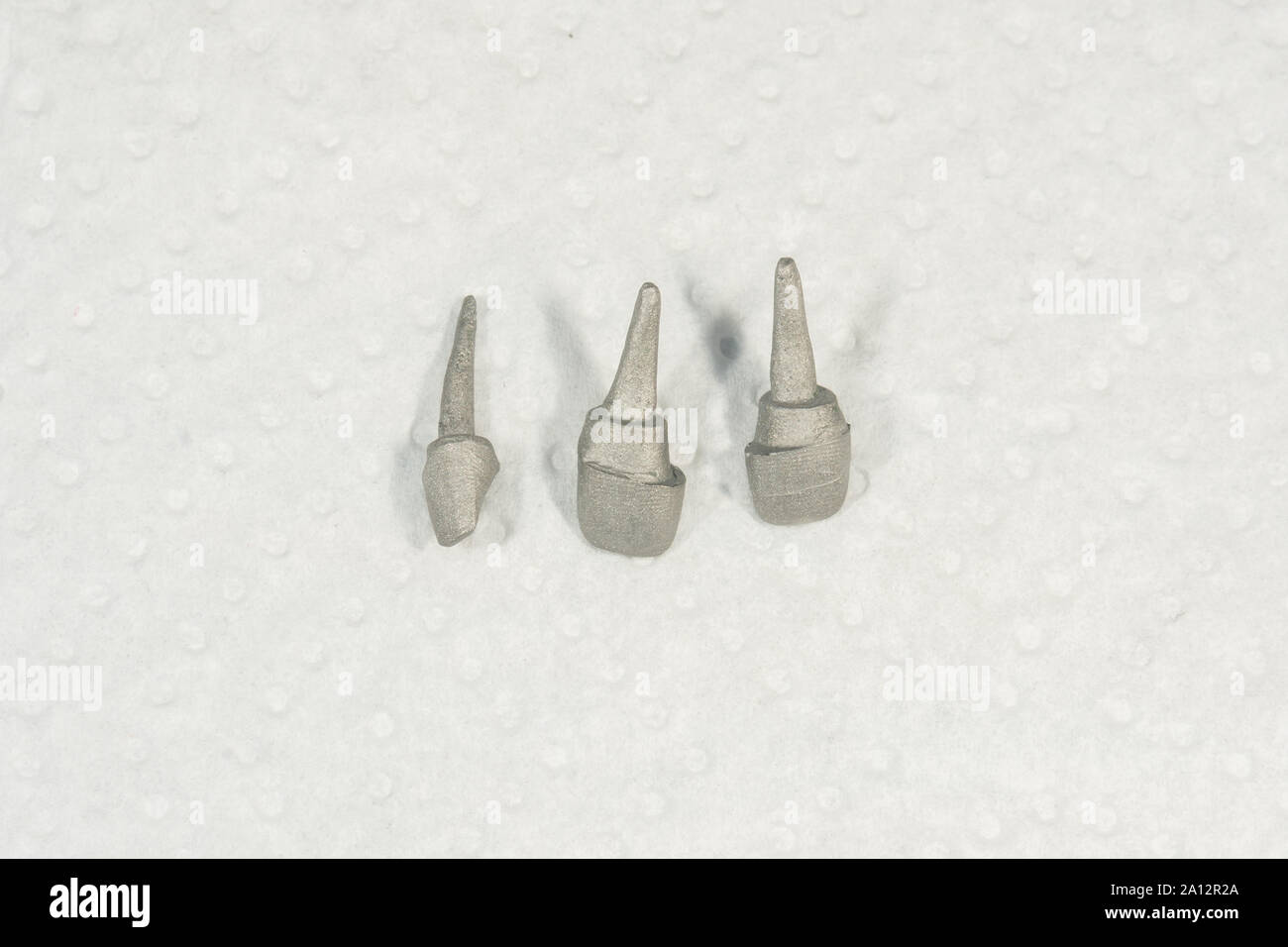 Ceramic tooth crowns and metal pins close-up macro. Orthopedic dentistry restoration decayed teeth Stock Photo