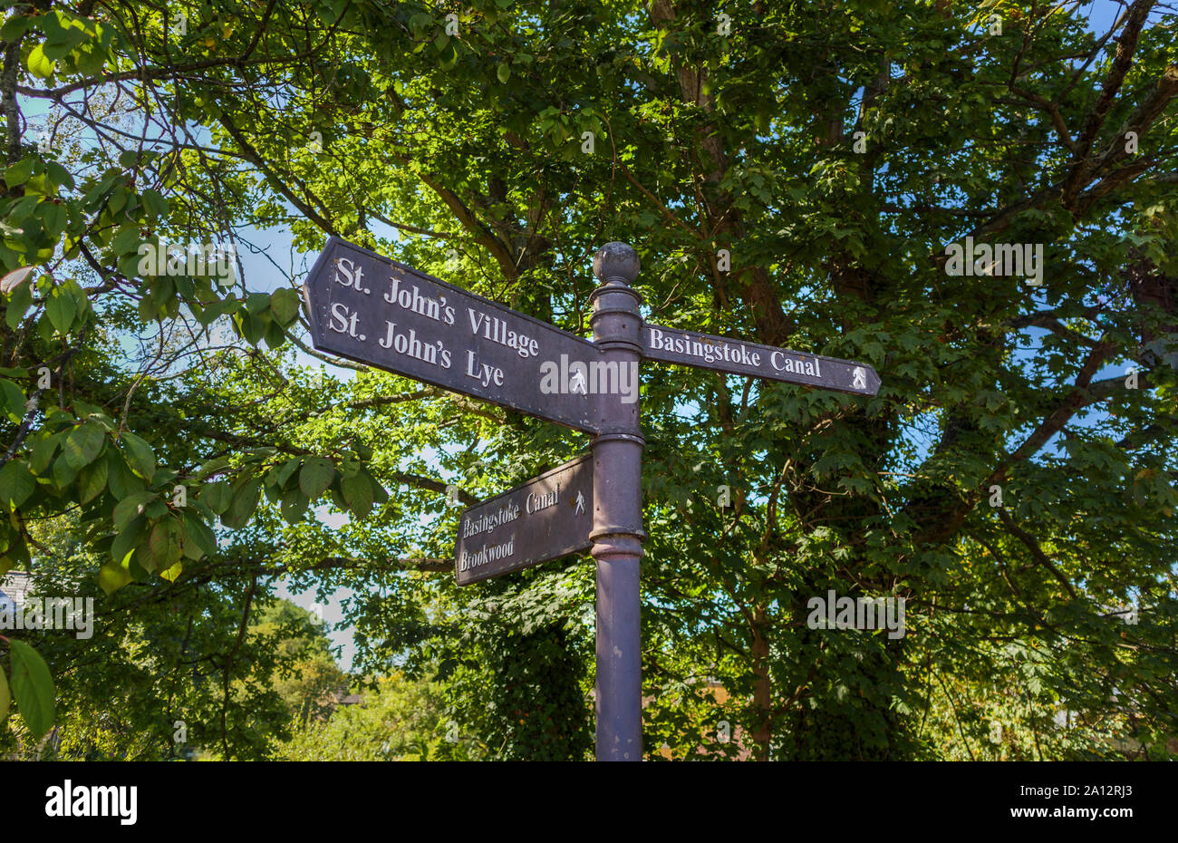 A fingerpost on a public footpath by the Basingstoke Canal, St Johns, a village near Woking, Surrey, SE England, pointing to local places of interest Stock Photo
