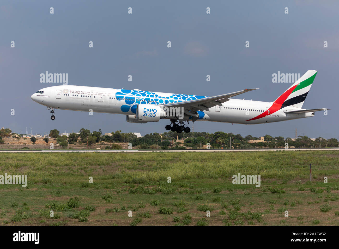 Emirates Boeing 777-31H/ER (REG: A6-EPK) with blue UAE Expo 2020 special livery landing runway 31. Stock Photo