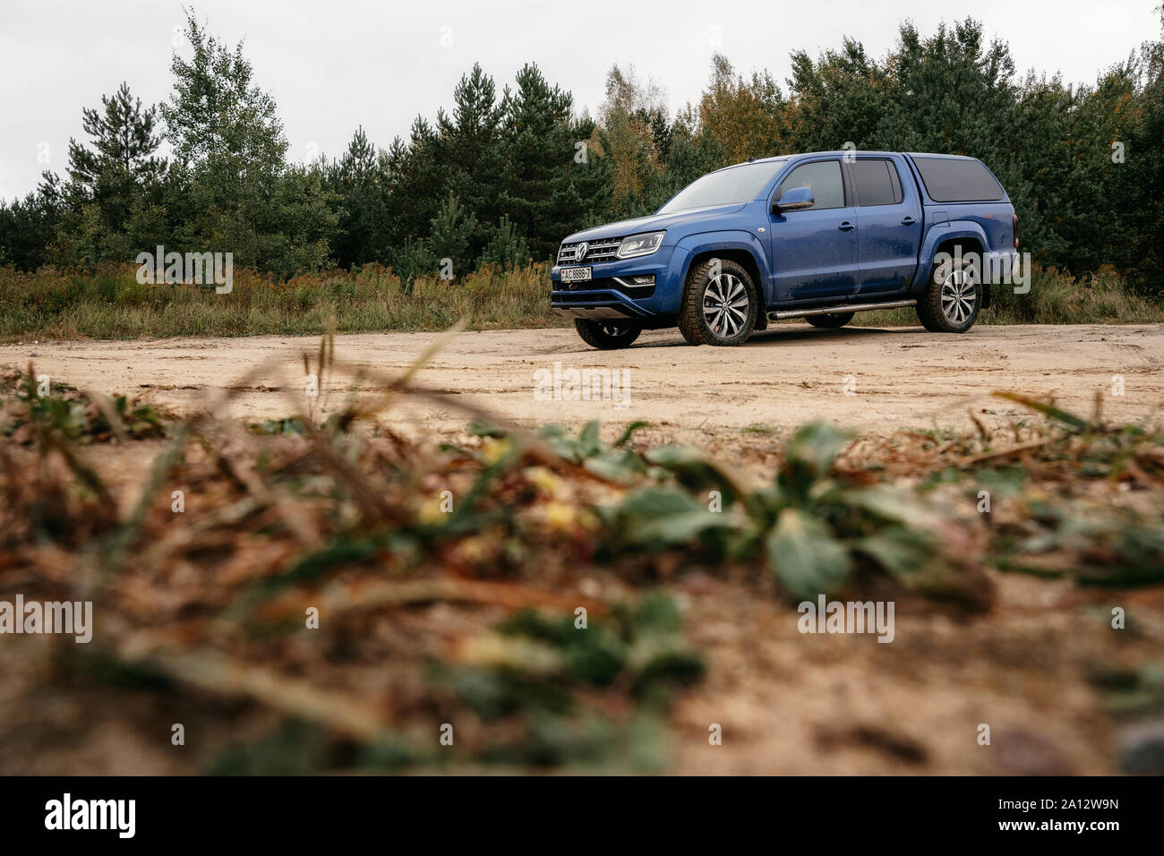 Minsk, Belarus - September 20, 2019: Volkswagen Amarok 4x4 pickup truck on country road at woodland. Stock Photo