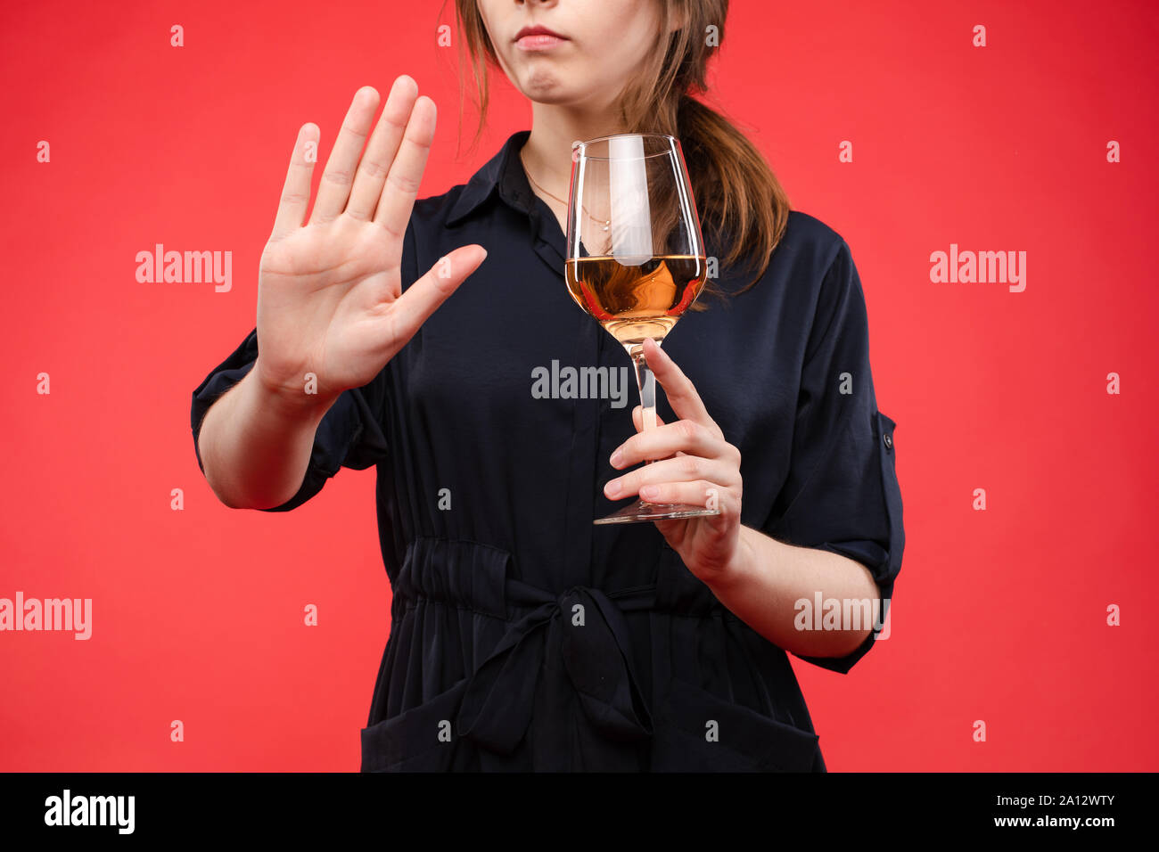 https://c8.alamy.com/comp/2A12WTY/woman-with-a-glass-of-wine-gesturing-hand-with-stop-signisolate-over-red-background-2A12WTY.jpg