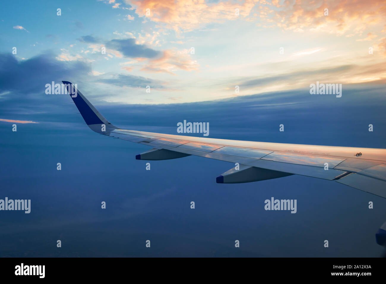 View of plane wing and beautiful sky above the clouds from plane Stock ...