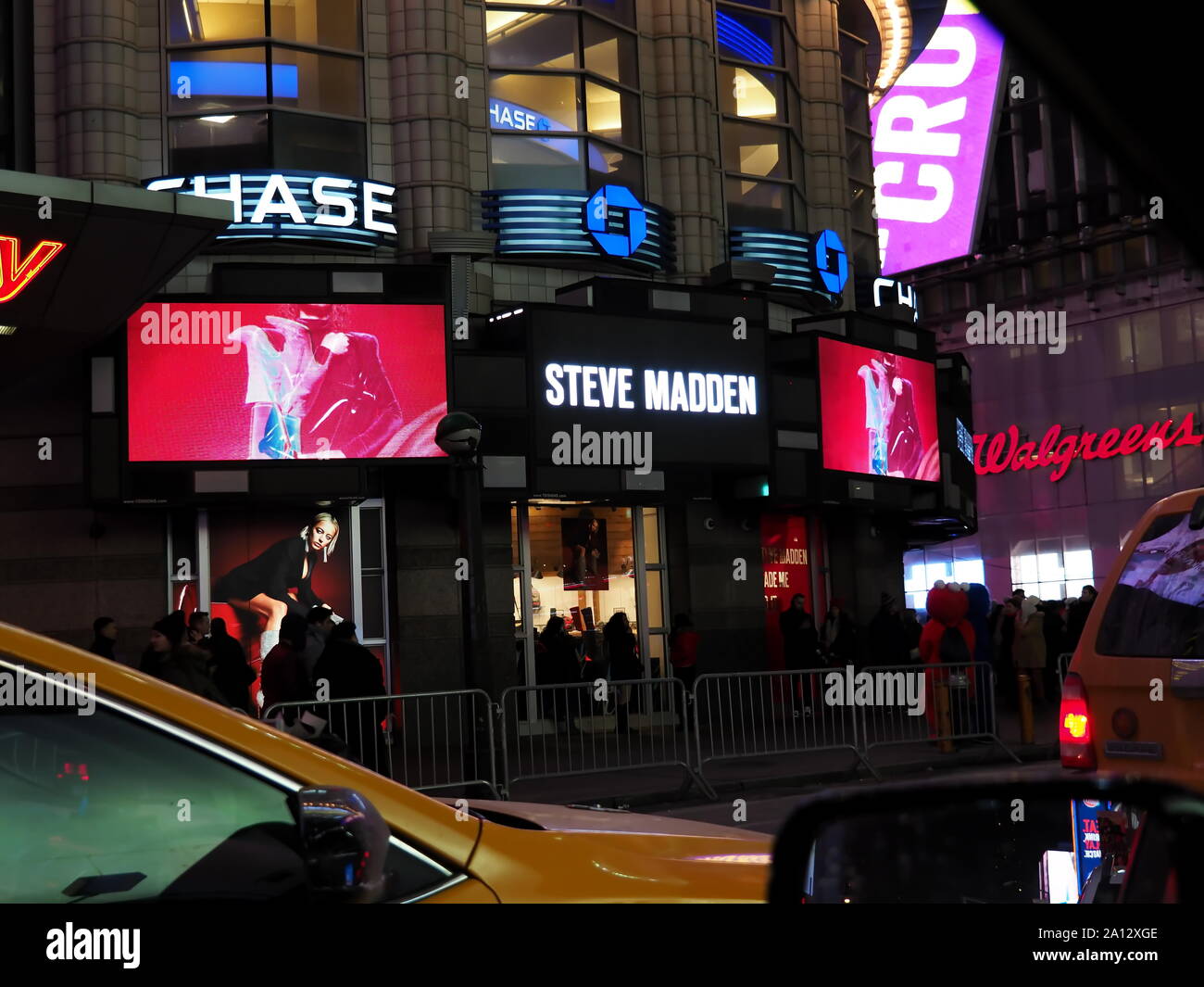 New York, NY USA. Dec 2017. Large digital display billboards, taxicabs, food, family and adult entertainment, and people all over in the Big Apple. Stock Photo