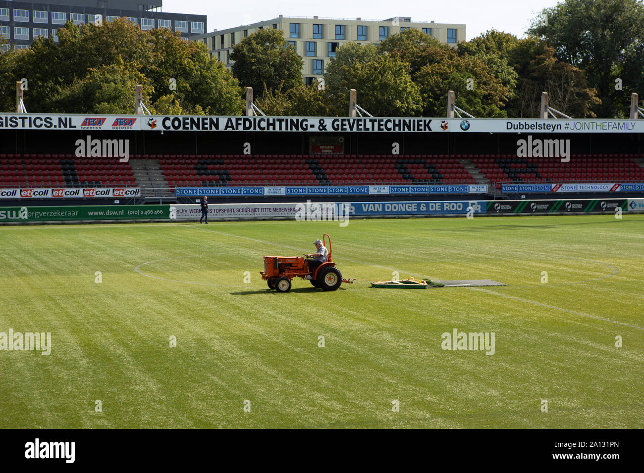 Maintenance worker on a tractor making a pristine soccer field of the