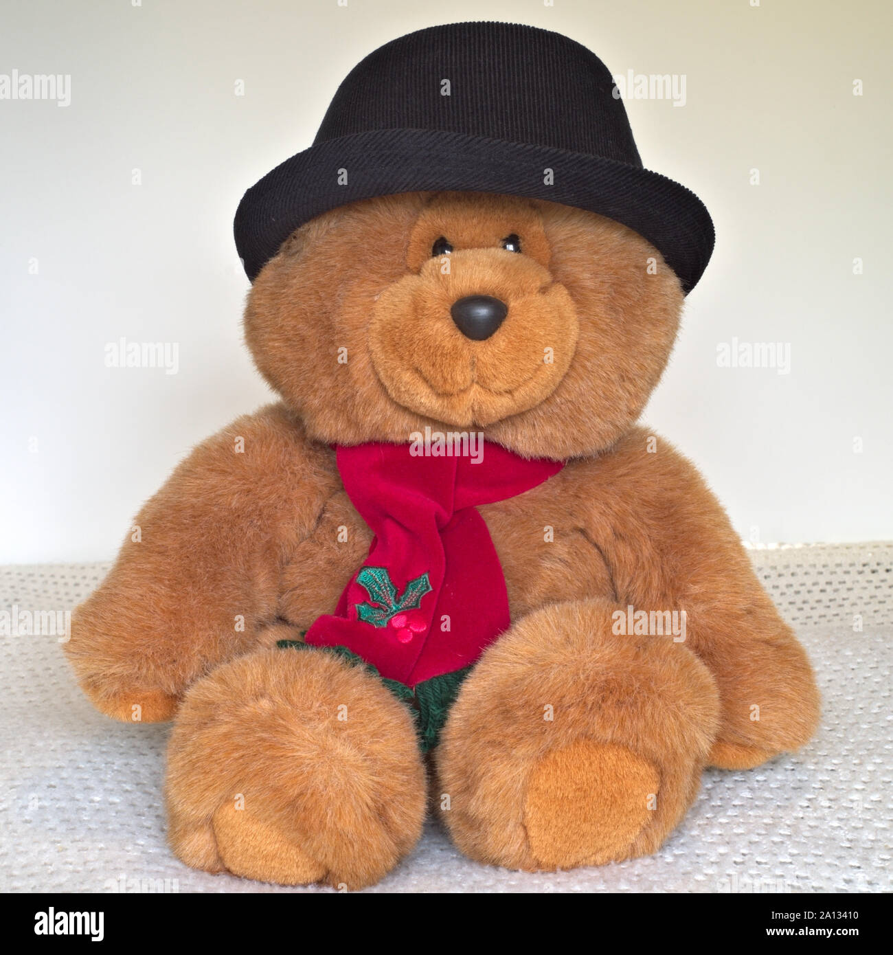 Teddy Bear Wearing a Black Hat and Red Scarf Stock Photo