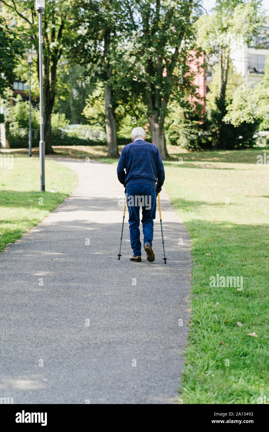 Older man walking with canes in the park Stock Photo - Alamy