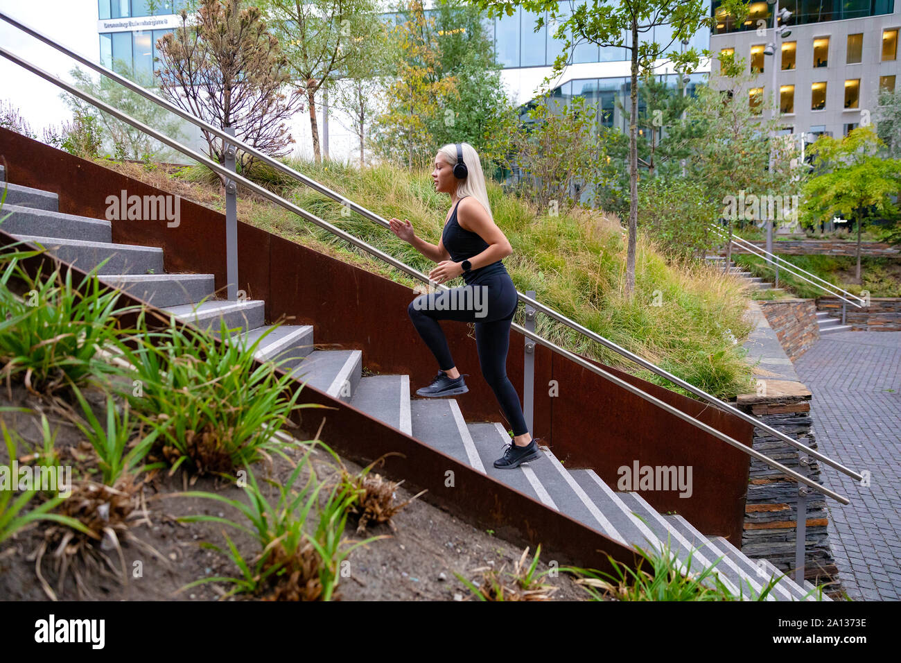 Fitness women running fast intervals in stairs in city park Stock Photo