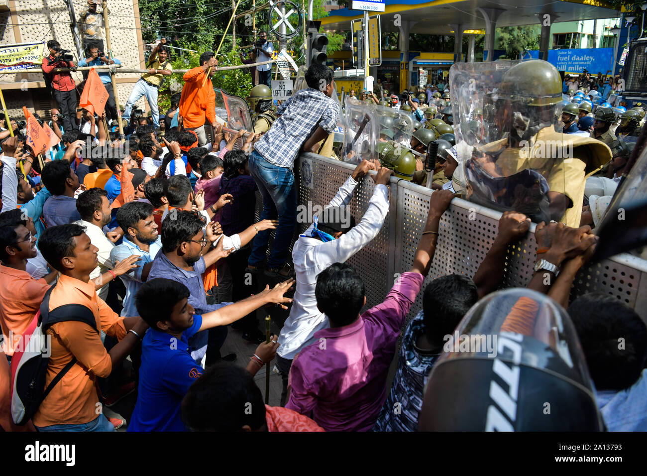 Akhil Bharatiya Vidyarthi Parishad (ABVP) activists try to push through a police barricade as police stop the ABVP's march to Jadavpur University.Akhil Bharatiya Vidyarthi Parishad (ABVP) the right wing students' organisation took out a rally to protest against the September 19 attack on the Union Minister Babul Supriyo in Jadavpur University campus. Stock Photo