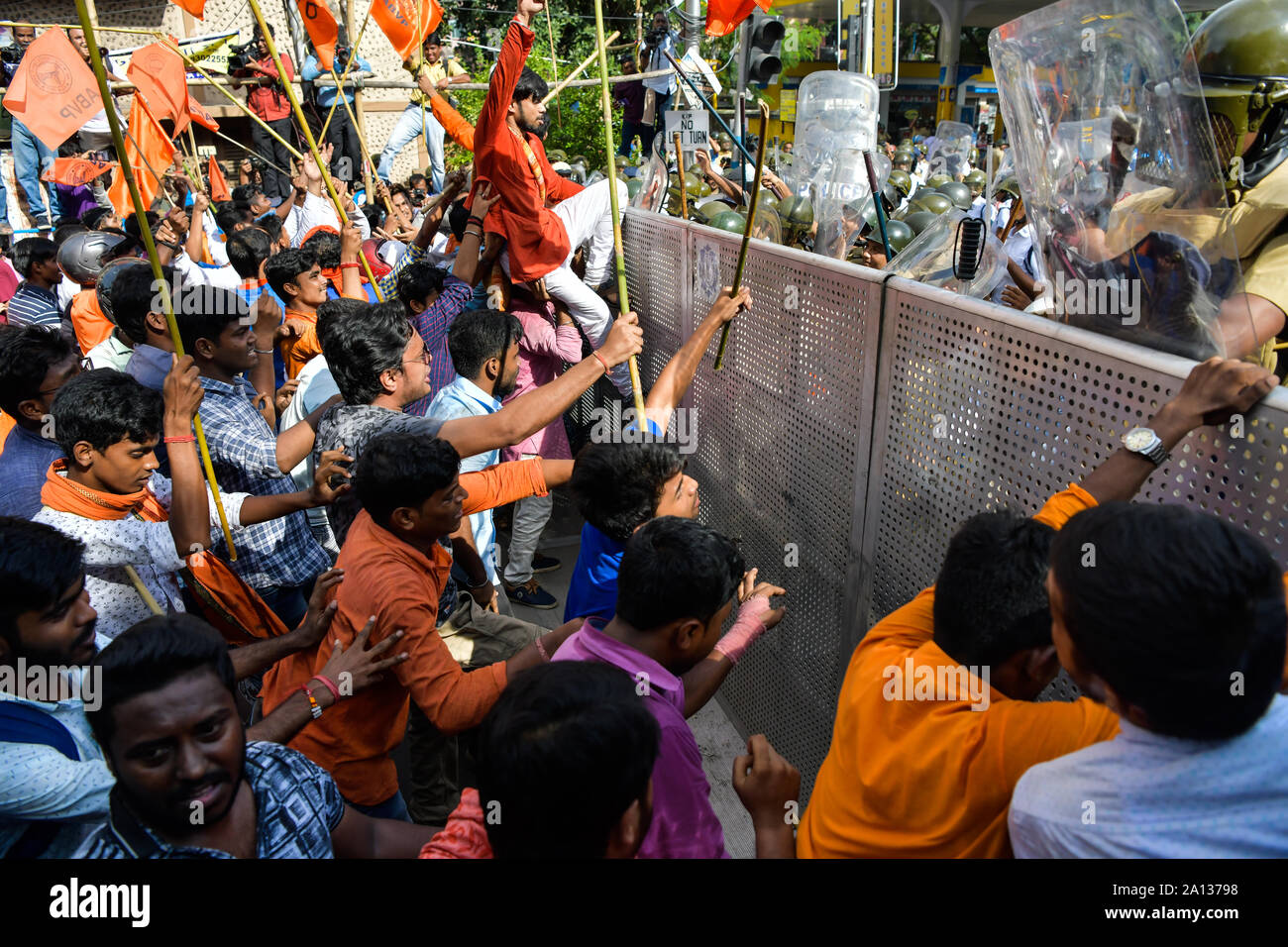 Akhil Bharatiya Vidyarthi Parishad (ABVP) activists try to push through a police barricade as police stop the ABVP's march to Jadavpur University.Akhil Bharatiya Vidyarthi Parishad (ABVP) the right wing students' organisation took out a rally to protest against the September 19 attack on the Union Minister Babul Supriyo in Jadavpur University campus. Stock Photo