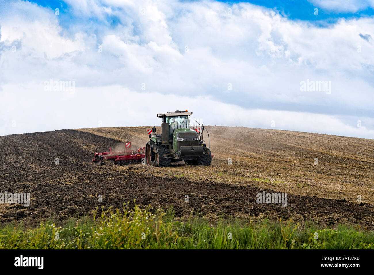 farmer in tractor preparing land with seedbed cultivator Stock Photo