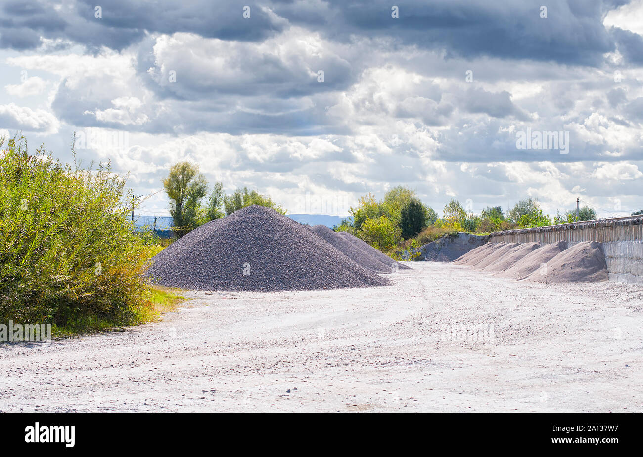 Unloading bulk cargo from railway wagons on high railway platform Stock Photo