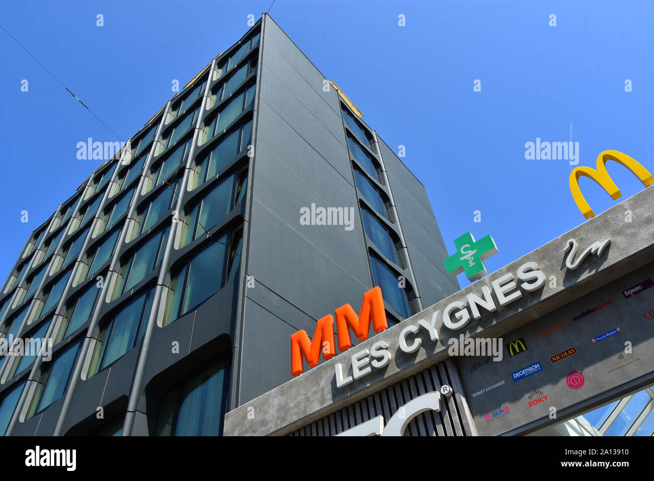 GENEVA, SWITZERLAND  - AUGUST 29 , 2019. Les Cygnes Centre Commercial facade and Hotel Warwick on Rue de Lausanne street in the center of Geneva . Stock Photo