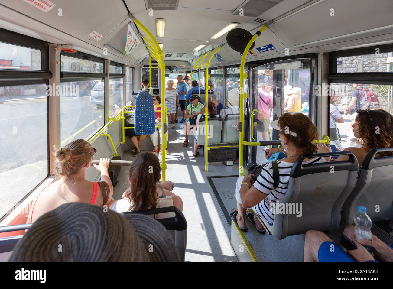 Croatia bus interior - bus passengers sitting inside in the interior of a local public transport bus, Dubrovnik Croatia Europe Stock Photo