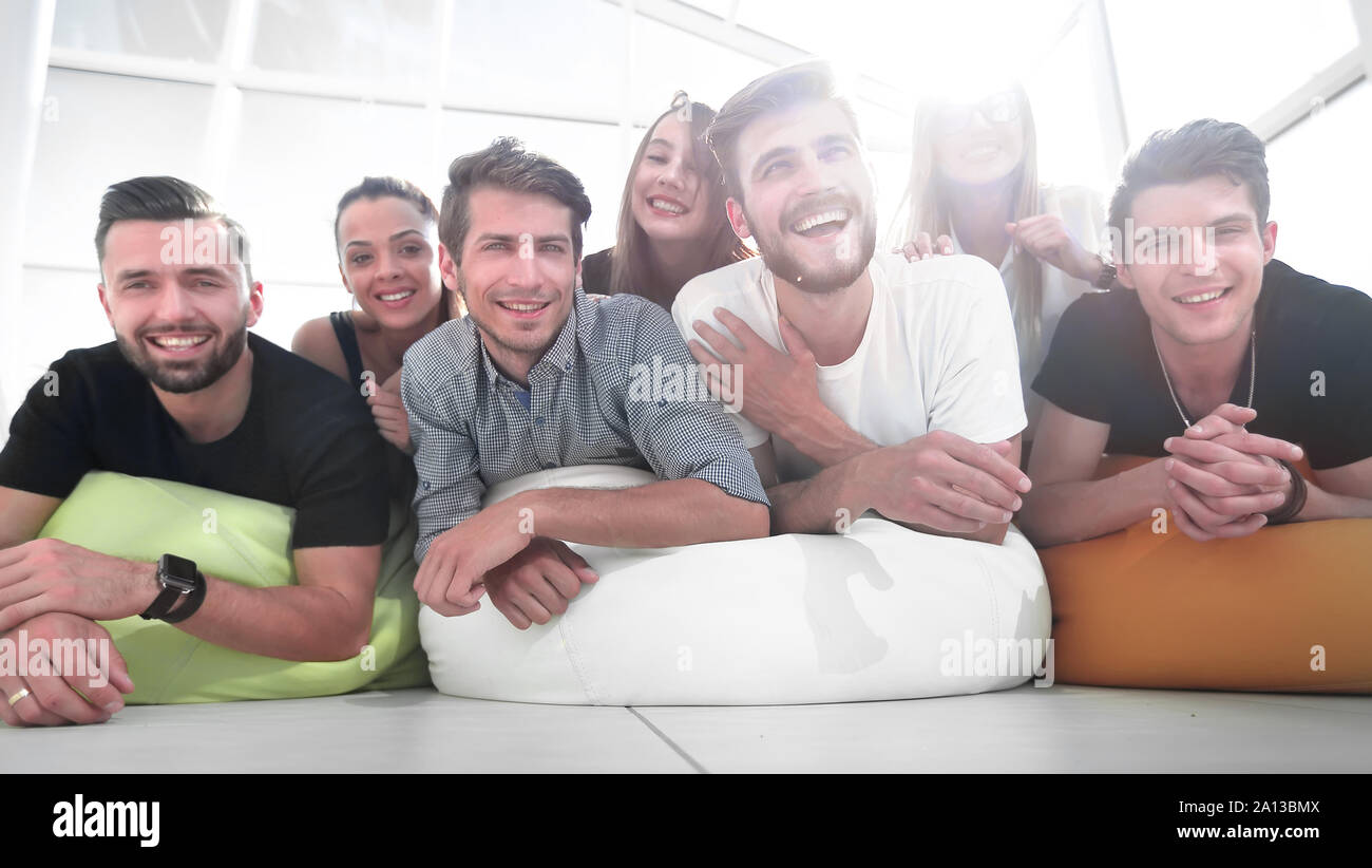 Group Of Young People Lying On The Floor And Smiling Stock Photo