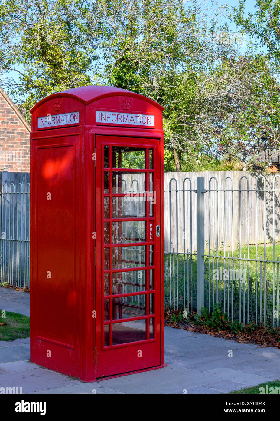 Old BT telephone kiosk now used as a tourist information centre at Wisborough Green, West Sussex, England, UK Stock Photo