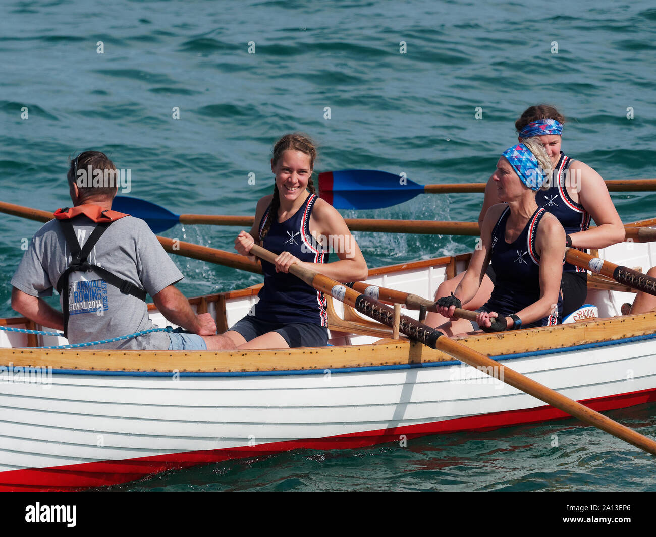 Women rowing in teams of six in traditional hand built pilot gig boats