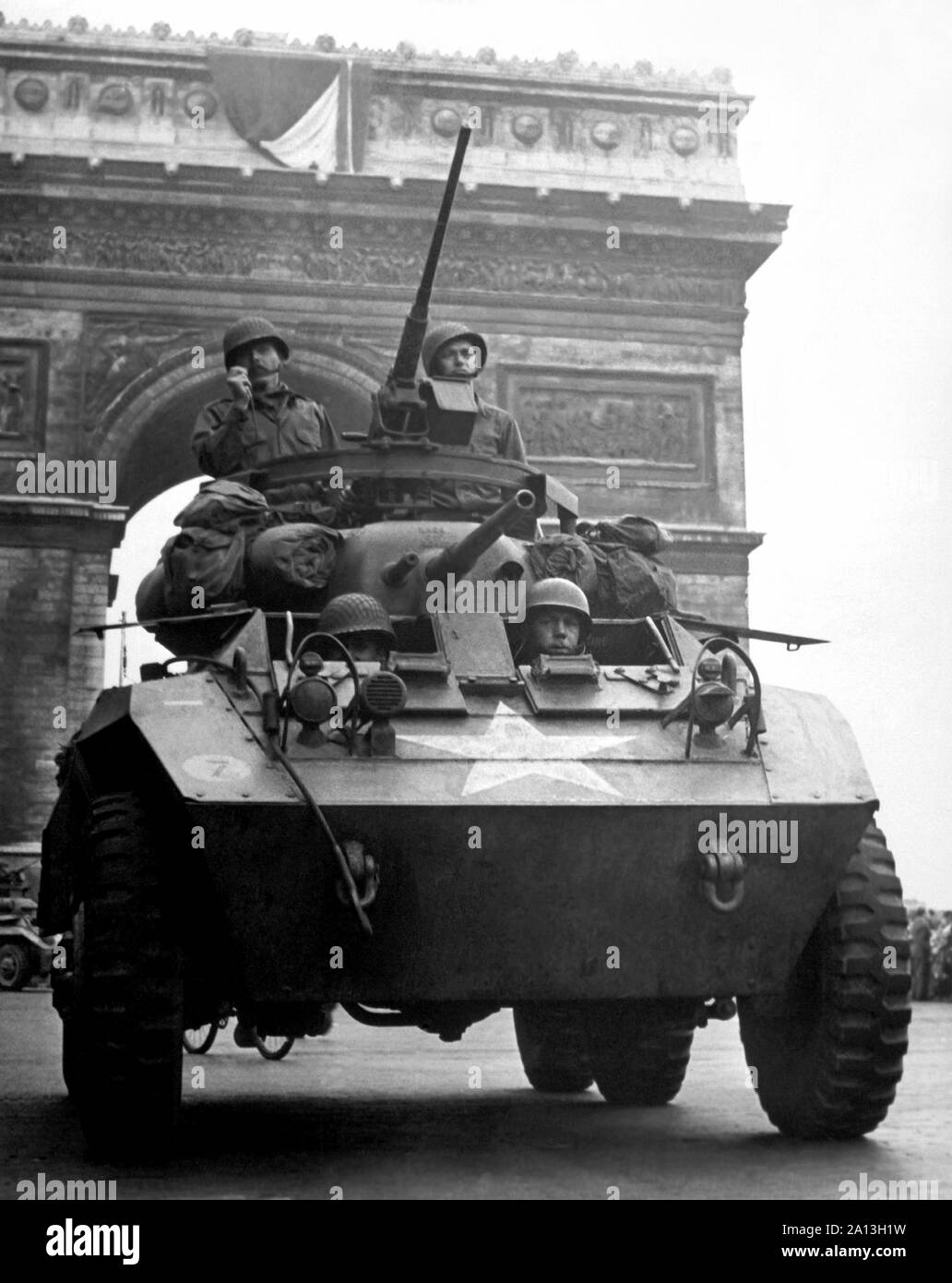World War II American M-8 light armored car, rolling past the Arc de Triomphe in Paris. Stock Photo