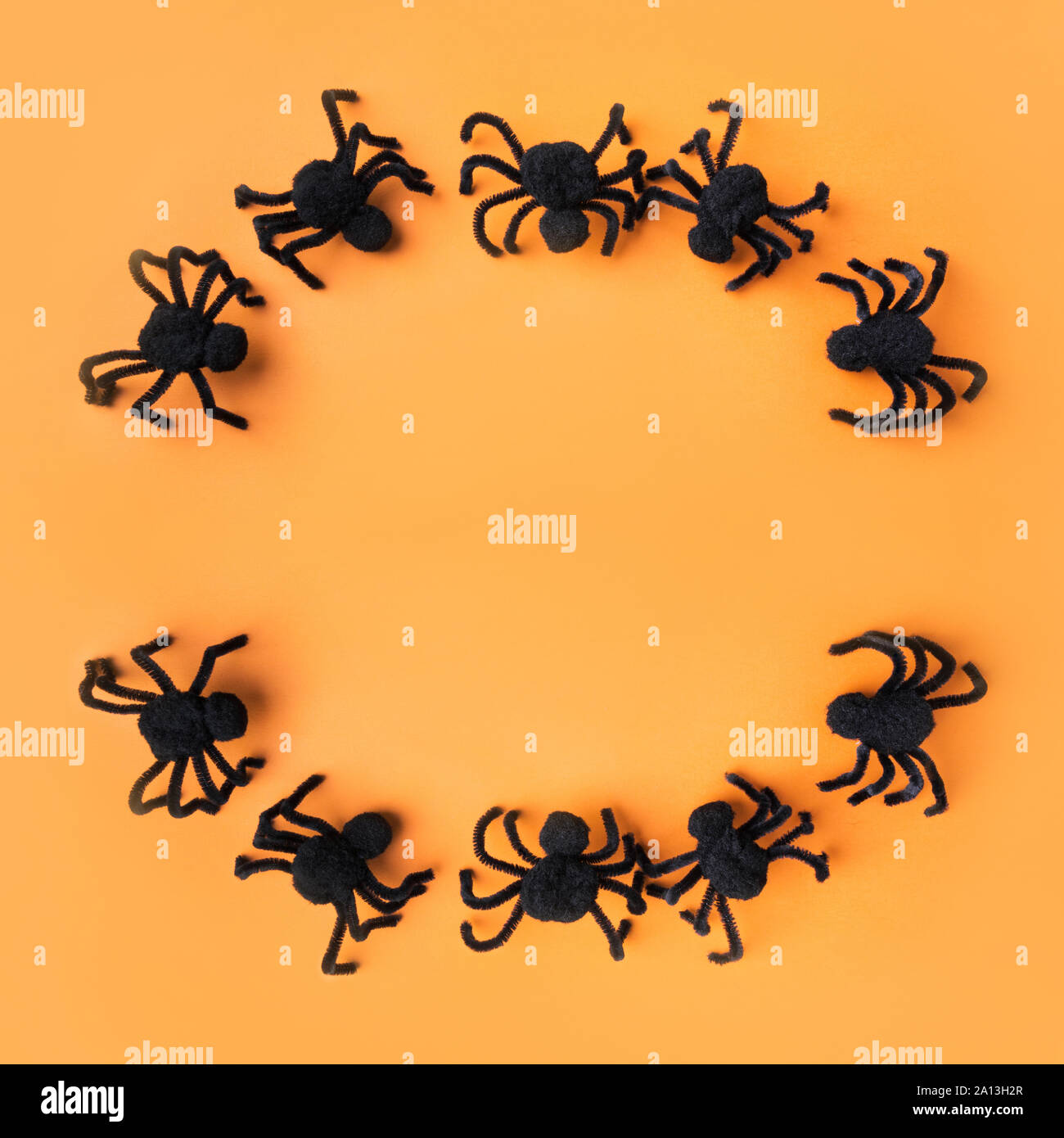 Halloween decorations with black spiders on orange background. Flat lay ...