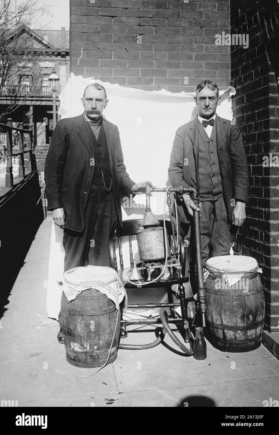 Prohibition era photograph of two men posing with an illegal whiskey