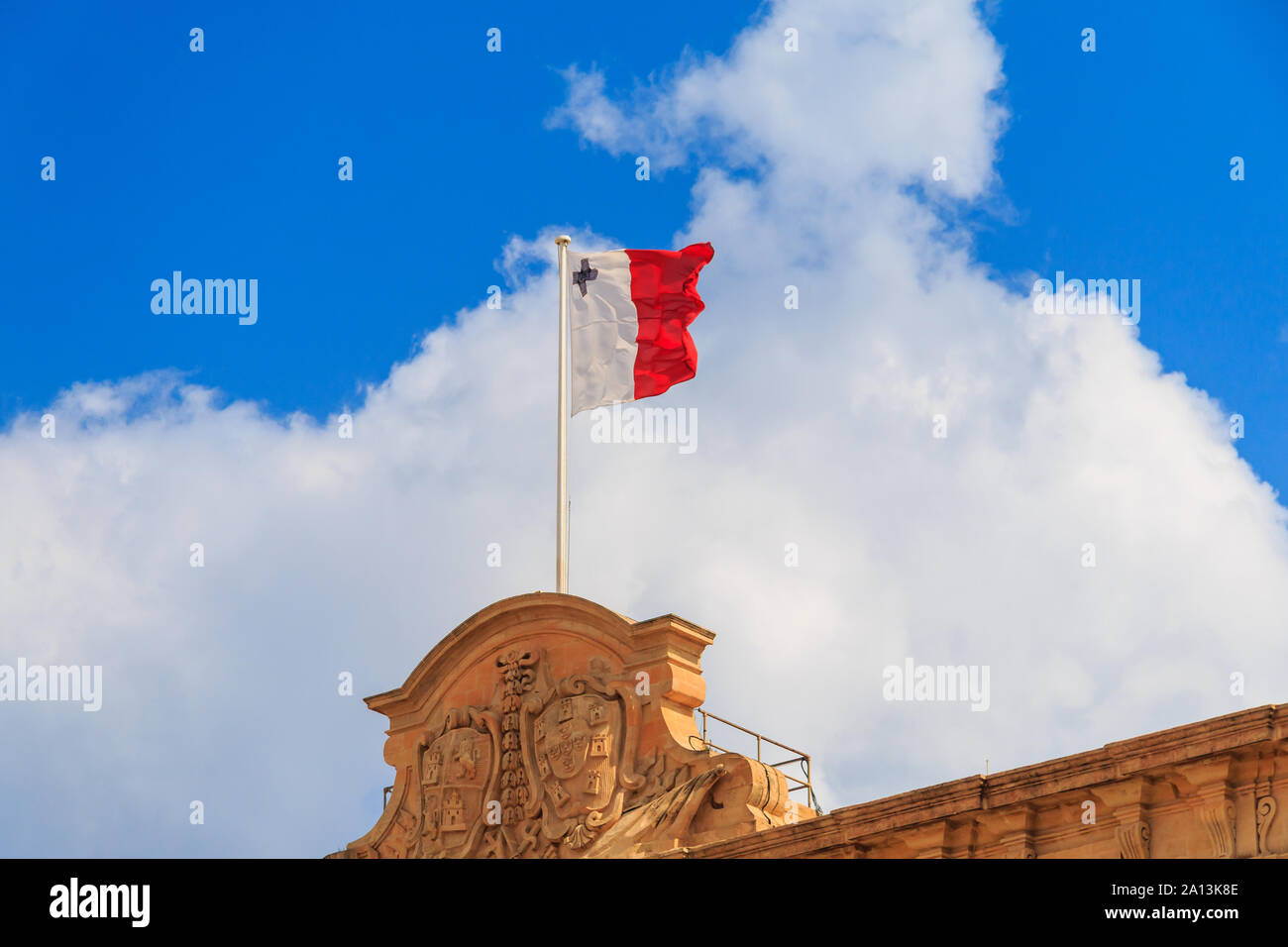 Malta national flag is waving in deep blue sky background Stock Photo
