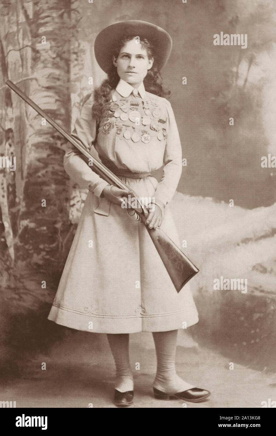 Portrait of sharpshooter Annie Oakley holding a rifle. Stock Photo