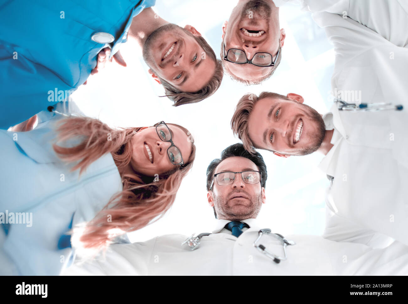 doctors looking down smiling at the camera Stock Photo - Alamy