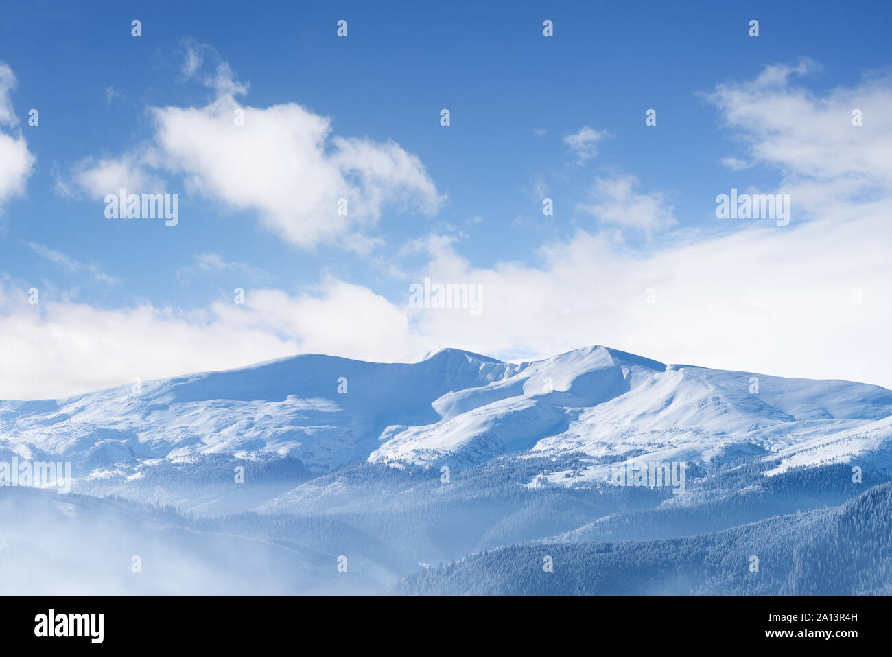 View of a mountain range with snowy peaks. Landscape with blue sky and ...