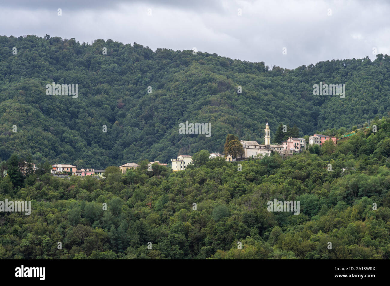 The village of Piandeipreti within the mountain range of the Apennines surrounded by abundant green dense forest, Liguria, Italy Stock Photo