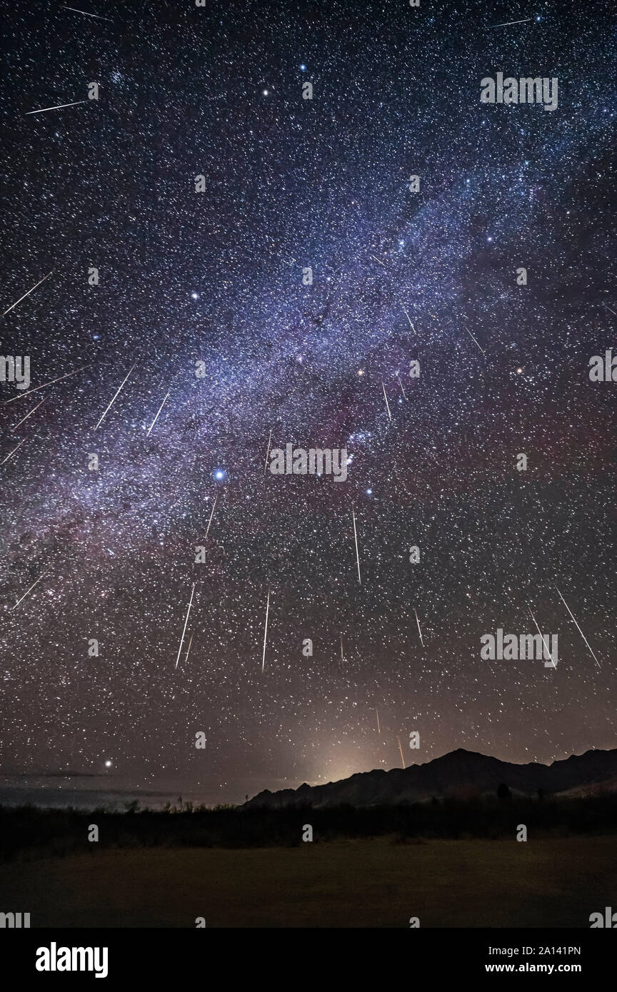 Geminid meteor shower raining overhead above the Chiricahua Mountains. Stock Photo