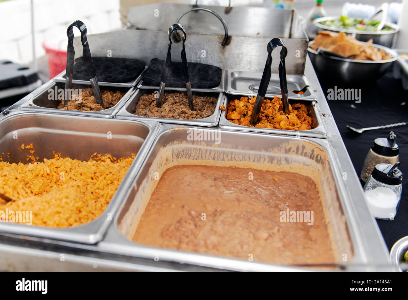 Catered event has traditional Mexican taco makings of rice, beans, pork al  pastor, pollo, and carne asada tacos Stock Photo - Alamy