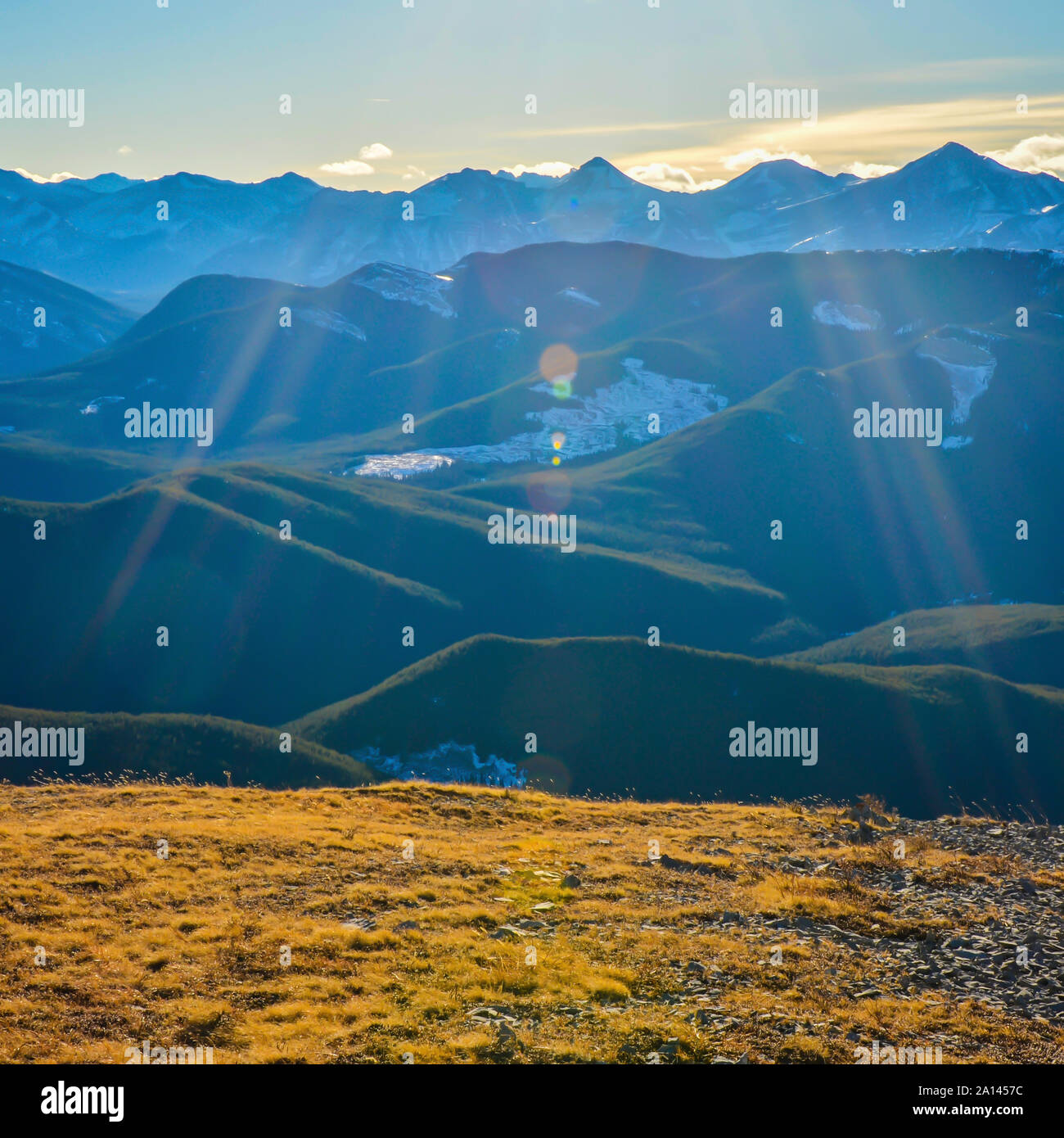 Landscape with lens flare of Kananaskis Mountains and Foothills from Prairie Mountain near Bragg Creek, and Calgary, Alberta, Canada Stock Photo