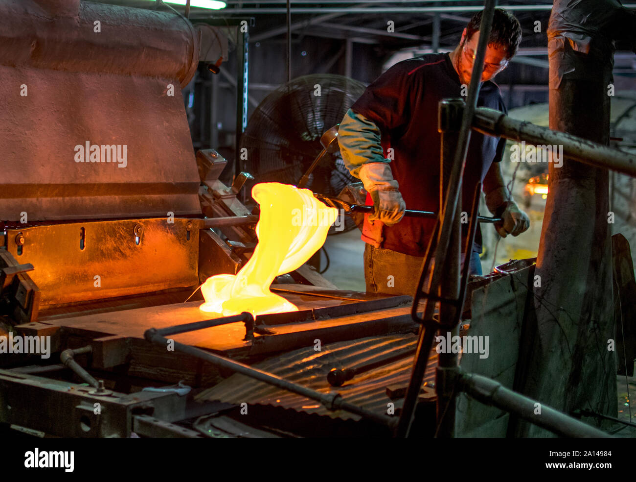 Sept 27 2019 Kokomo Indiana USA; A talented glass worker mixes molten hot glass, and in this process, creates sheets of beautiful stained glass for ar Stock Photo