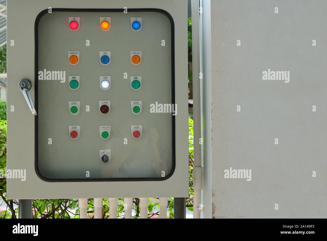 Closeup control panel lamps behind the blurred glass cover of switchboard,  focus on white lamp with the word low, also can see reflection of photograp  Stock Photo - Alamy
