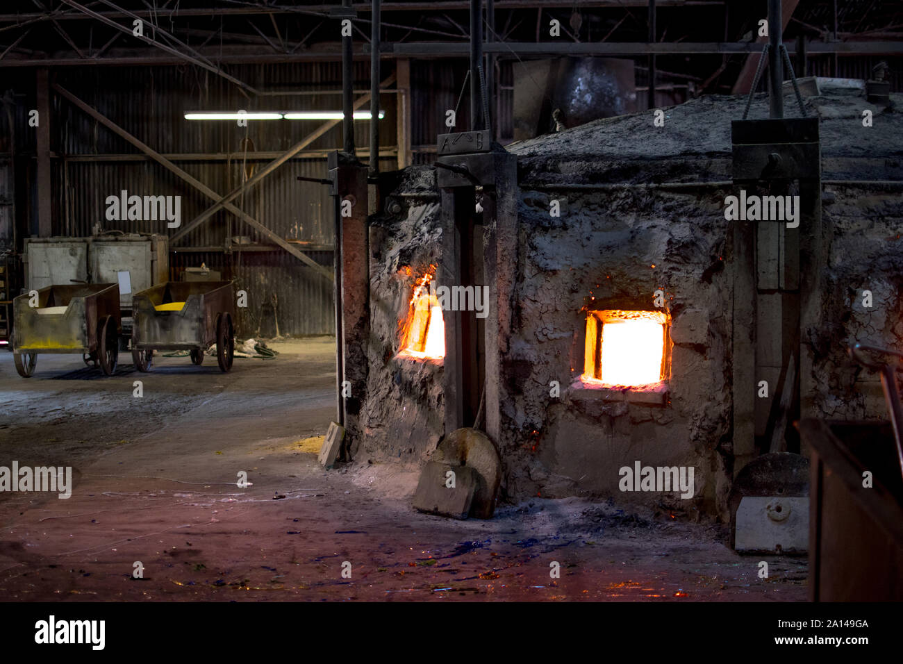Sept 27 2019 Kokomo Indiana USA; an old kiln glows red hot, as it melts glass of many colors, used to make stained glass sheets at the oldest glass fa Stock Photo