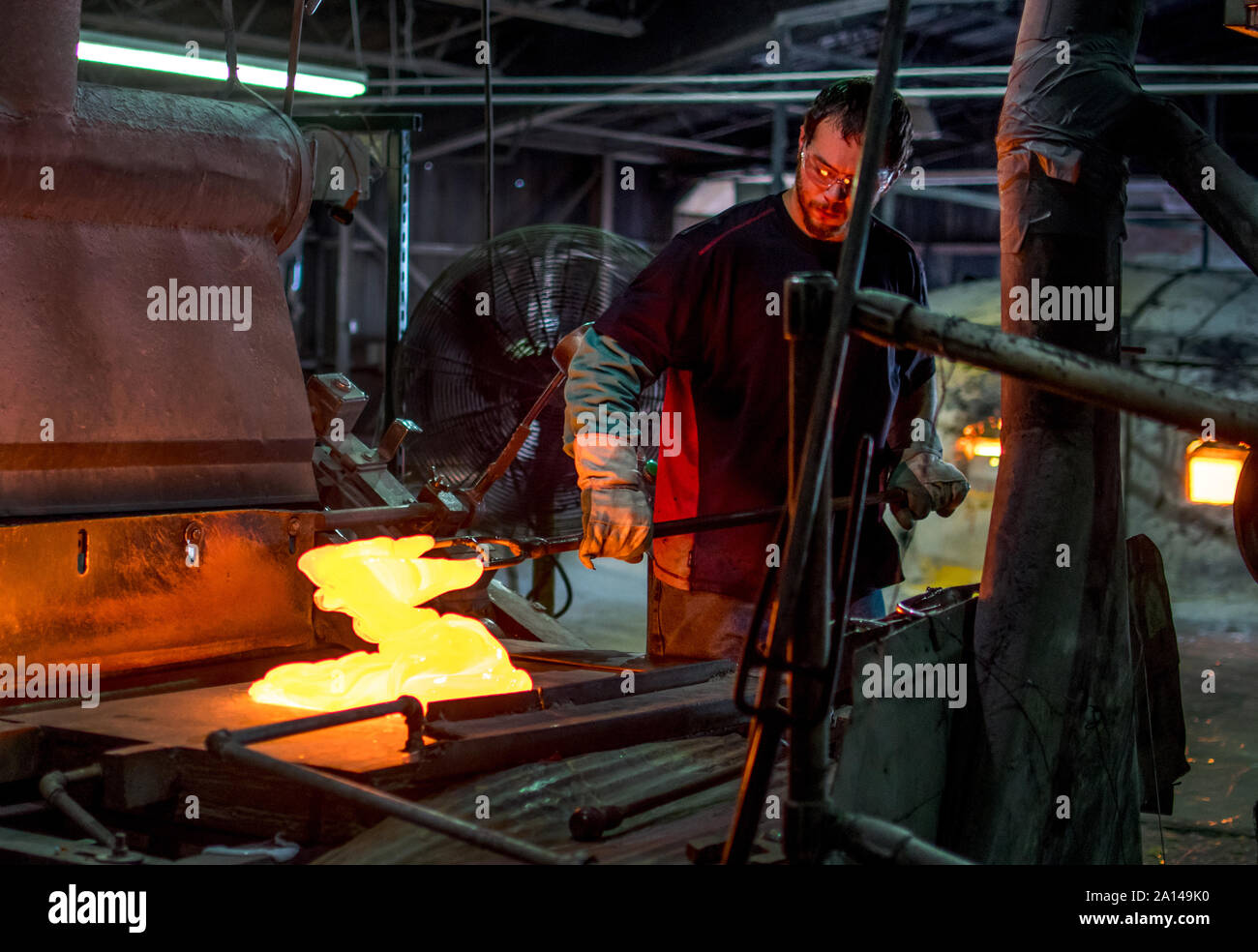 Sept 27 2019 Kokomo Indiana USA; this glass worker is mixing molten hot glass, which will soon be turned into stained glass sheets. although difficult Stock Photo