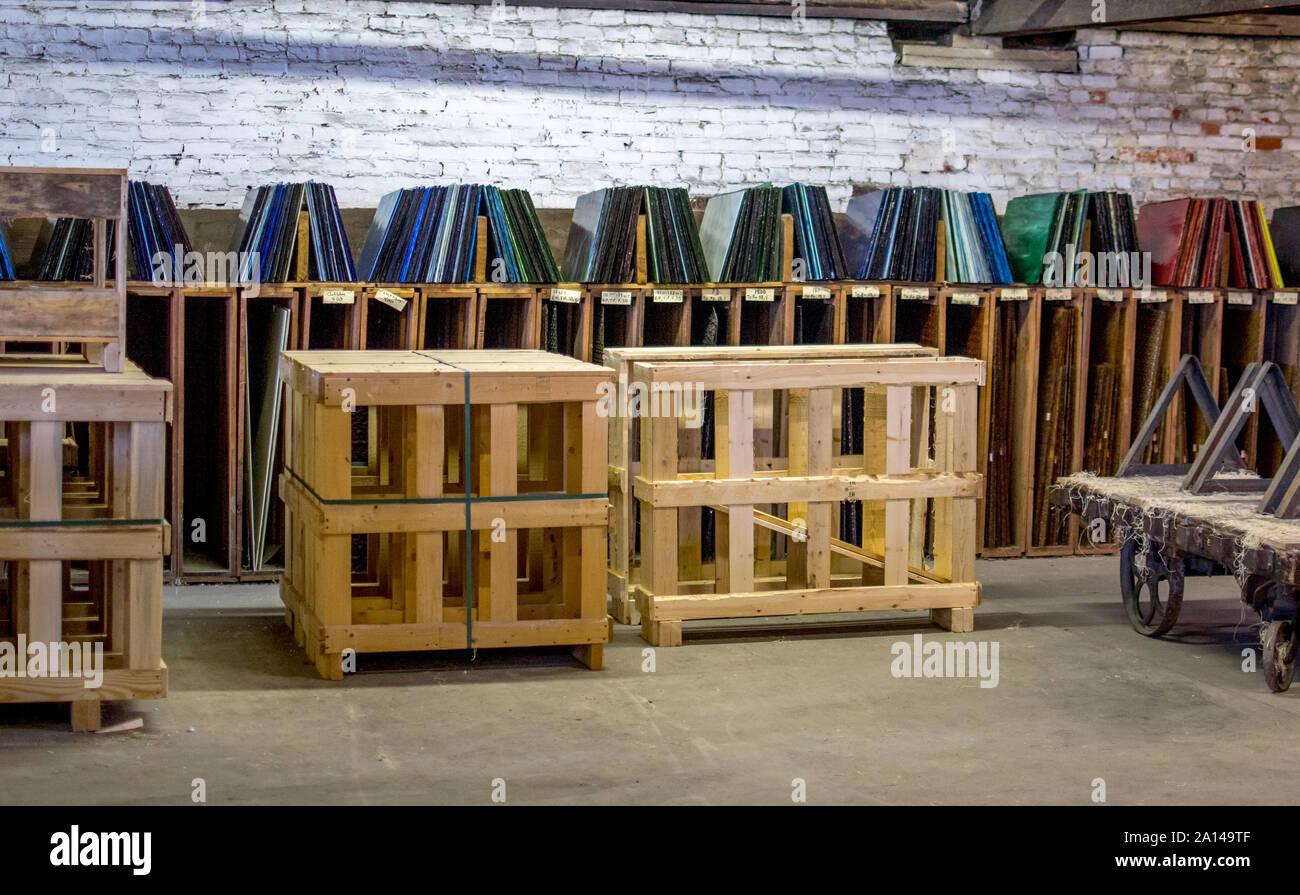 Sheets of glass in many colors, are on display in custom shelves at a glass factory in North