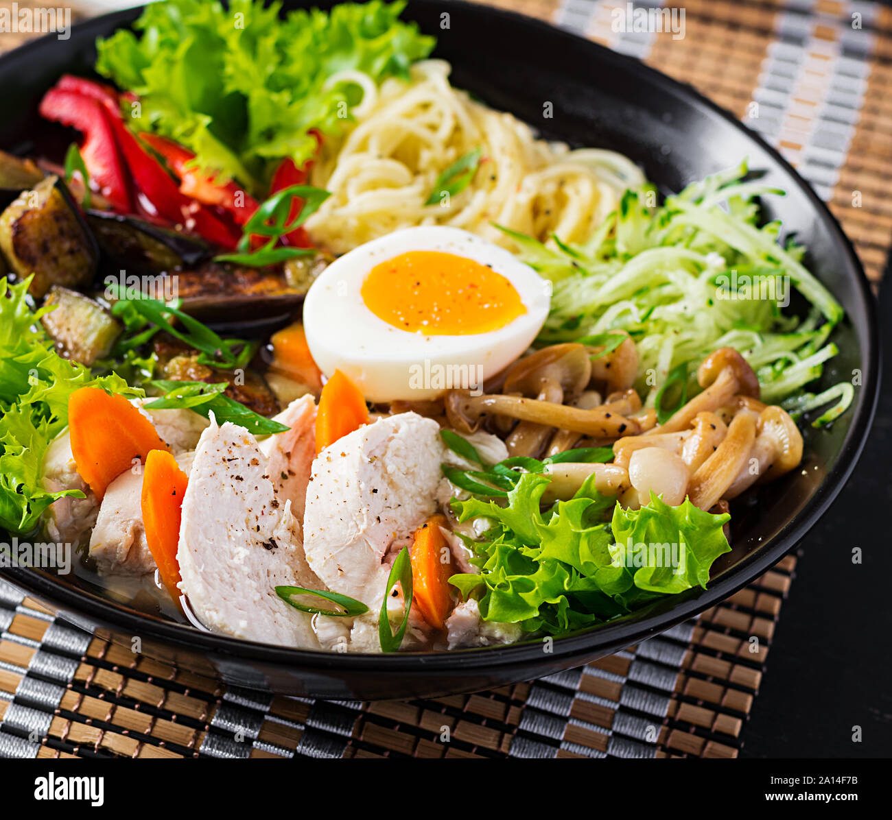 Japanese ramen soup with chicken, egg, shimeji mushrooms and eggplants